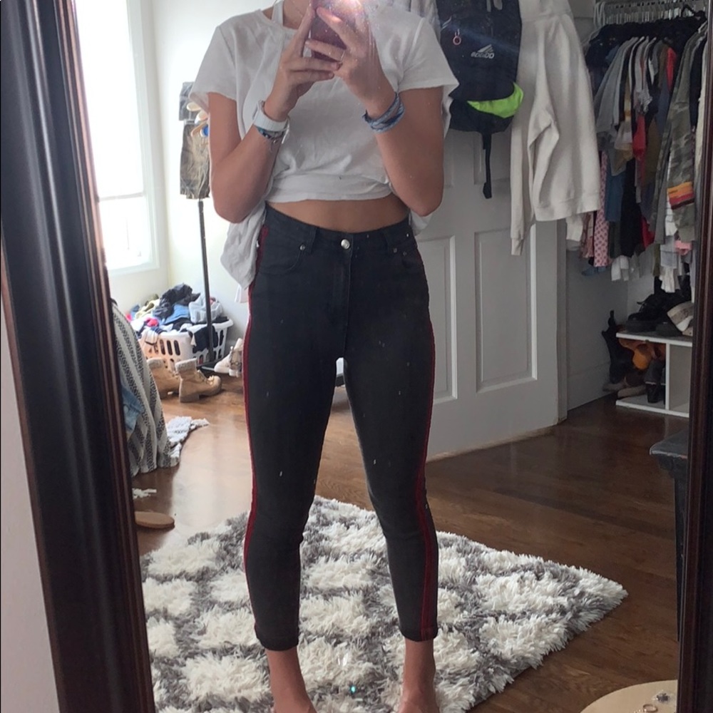 black jeans with two red strips